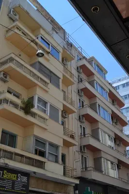 an apartment building with balconies on a street at Pythagoras Omonoia in Athens