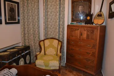a living room with a chair and a dresser at Pythagoras Omonoia in Athens