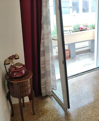 a room with a glass door and a table and a window at Pythagoras Omonoia in Athens