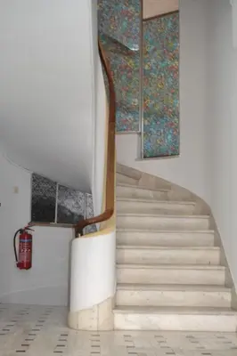 a staircase in a building with a painting on the wall at Pythagoras Omonoia in Athens
