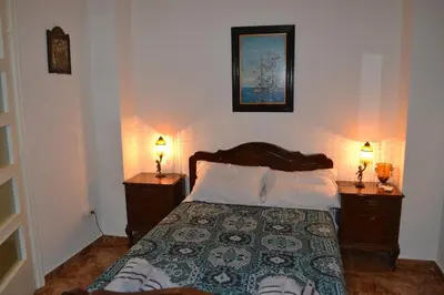 a bedroom with a bed and two night stands with lamps at Pythagoras Omonoia in Athens