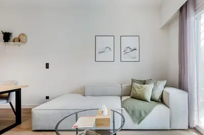 a living room with a couch and a glass table at Bask - Glamorous 2 Bedroom Apartment in Athens in Athens