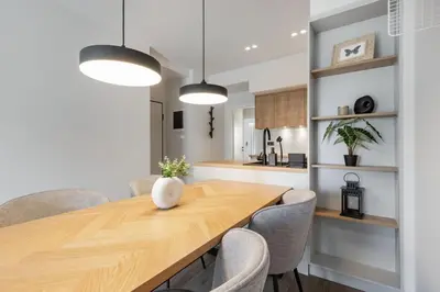 a kitchen and dining room with a wooden table and chairs at Bask - Glamorous 2 Bedroom Apartment in Athens in Athens