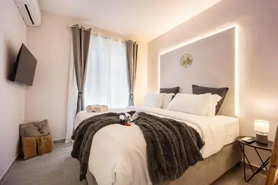 a bedroom with a large bed and a window at Elegant Aphrodite, 2 Bedroom Apartment, by Acropolin in Athens