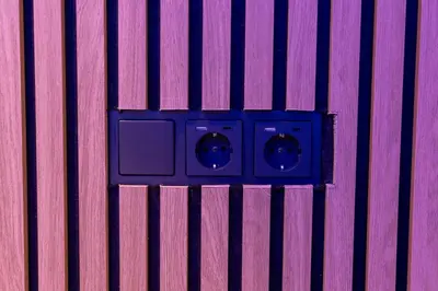 a electrical outlet on a pink and purple wall at Athens Center Retreat in Athens