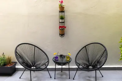 two chairs sitting next to a wall with a table at Athens Center Retreat in Athens