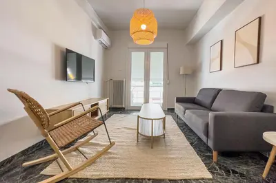 a living room with a couch and a table at Phaedrus Living Koukaki Verdant Marble in Athens