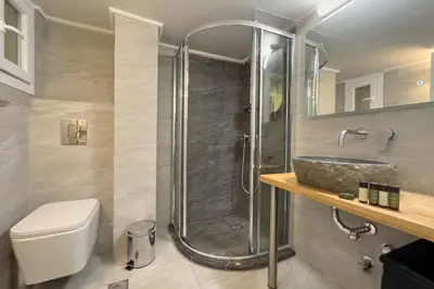 a bathroom with a shower and a toilet and a sink at Phaedrus Living Koukaki Verdant Marble in Athens