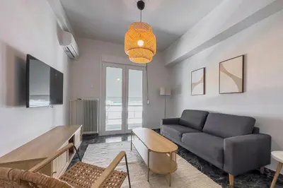 a living room with a couch and a table at Phaedrus Living Koukaki Verdant Marble in Athens
