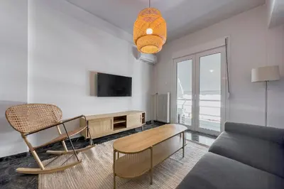 a living room with a couch and a table at Phaedrus Living Koukaki Verdant Marble in Athens