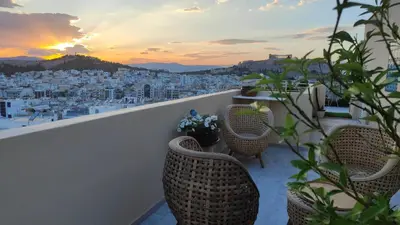 a balcony with chairs and a view of a city at Pythagoras Acropolis in Athens