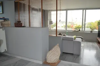 a living room with a lot of windows and a couch at Pythagoras Acropolis in Athens