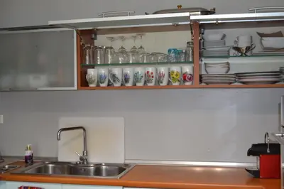 a kitchen with a sink and a shelf with dishes at Pythagoras Acropolis in Athens