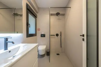 a bathroom with a shower and a sink and a toilet at Zen Tulip, Kolonaki in Athens