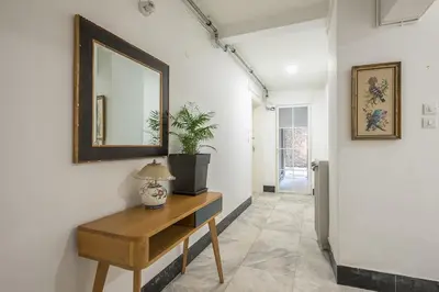 a hallway with a table and a mirror on a wall at Zen Tulip, Kolonaki in Athens