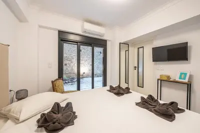 a bedroom with a large white bed with flowers on it at Zen Tulip, Kolonaki in Athens