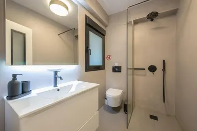 a bathroom with a sink and a shower at Zen Tulip, Kolonaki in Athens