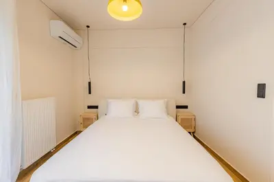 a bedroom with a large white bed in it at Mandarin One Bedroom Apartment Varkiza in Vari