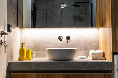 a bathroom counter with a sink and a bowl at Mandarin One Bedroom Apartment Varkiza in Vari