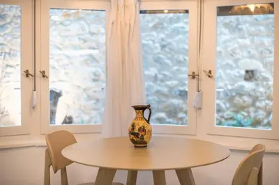 a vase sitting on a table in front of windows at Zen Lotus, Kolonaki in Athens