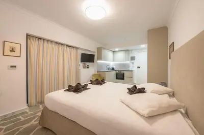 a bedroom with a large white bed with two pillows at Zen Lotus, Kolonaki in Athens