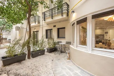 a building with a patio with plants and a window at Zen Lotus, Kolonaki in Athens