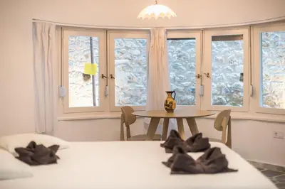 a room with two beds and a table and windows at Zen Lotus, Kolonaki in Athens