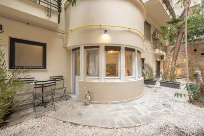 a house with a patio with a table and chairs at Zen Lotus, Kolonaki in Athens