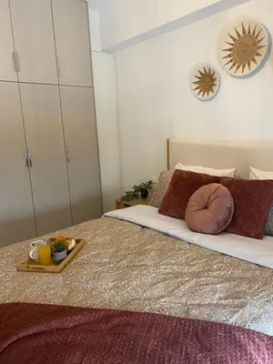 a bedroom with a bed with a tray of food on it at New Modern 2BD aprt with shared rooftop pool B2 in Athens