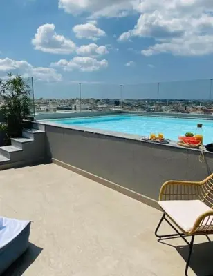 a swimming pool on top of a building at New Modern 2BD aprt with shared rooftop pool B2 in Athens