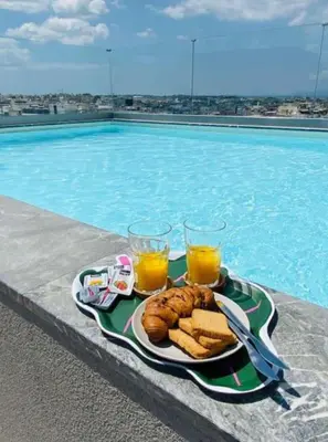 a tray of food and drinks next to a swimming pool at New Modern 2BD aprt with shared rooftop pool B2 in Athens