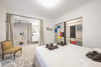 a bedroom with a bed and a chair and a window at Zen Orchid, Kolonaki in Athens