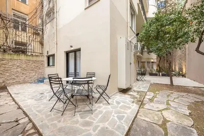 a patio with a table and chairs in a building at Zen Orchid, Kolonaki in Athens