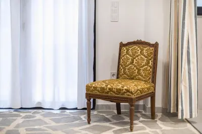 a chair sitting in front of a window at Zen Orchid, Kolonaki in Athens