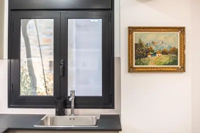 a kitchen sink with a window and a picture at Zen Orchid, Kolonaki in Athens