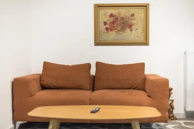 a living room with a couch and a coffee table at Zen Orchid, Kolonaki in Athens