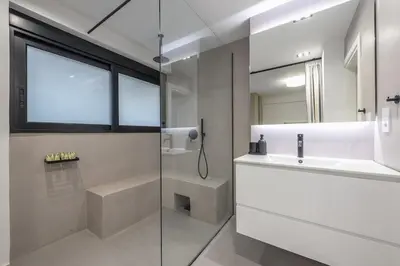 a white bathroom with a sink and a shower at Zen Orchid, Kolonaki in Athens