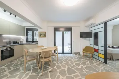 a kitchen and dining room with a table and chairs at Zen Orchid, Kolonaki in Athens