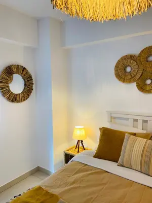 a bedroom with two mirrors on the wall and a bed at NEW 2BD Aprt with Shared Rooftop Pool B3 in Athens