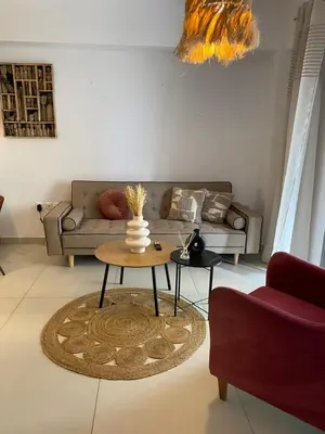 a living room with a couch and a table at NEW 2BD Aprt with Shared Rooftop Pool B3 in Athens