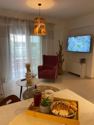 a living room with a table with a plate of bread at NEW 2BD Aprt with Shared Rooftop Pool B3 in Athens