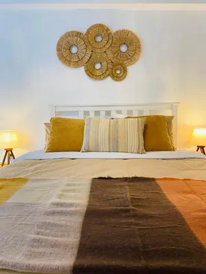 a bedroom with a bed with two mirrors on the wall at NEW 2BD Aprt with Shared Rooftop Pool B3 in Athens
