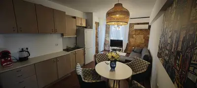 a kitchen with a table and chairs and a kitchen with a table and a room at Luxury 2bdr apartment with sea view and 50m from the beach in Porto Rafti