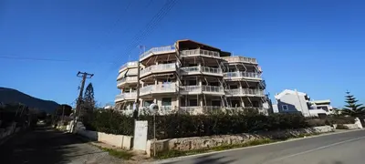 a large apartment building on the side of a street at Luxury 2bdr apartment with sea view and 50m from the beach in Porto Rafti