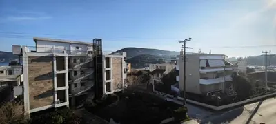 a group of buildings with mountains in the background at Luxury 2bdr apartment with sea view and 50m from the beach in Porto Rafti