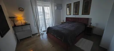 a bedroom with a bed and a lamp and a window at Luxury 2bdr apartment with sea view and 50m from the beach in Porto Rafti