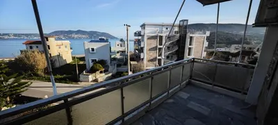 a balcony with a view of the water and buildings at Luxury 2bdr apartment with sea view and 50m from the beach in Porto Rafti