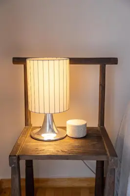 a table with a lamp on top of it at Ernesto Apartment in Athens
