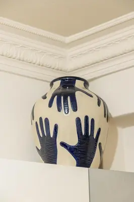 a blue and white vase sitting on a shelf at Ernesto Apartment in Athens