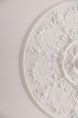 a white plate hanging on a white wall at Ernesto Apartment in Athens
